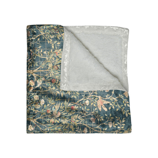 A lush crushed velvet blanket with a floral William Morris & Co pattern in evergreen teal colours, hemmed edges and a silky finish.