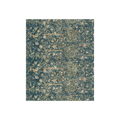 A lush crushed velvet blanket with a floral pattern in evergreen teal colors, hemmed edges and a silky finish.