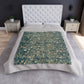 A lush crushed velvet blanket with a floral William Morris & Co pattern in evergreen teal colours, hemmed edges and a silky finish.