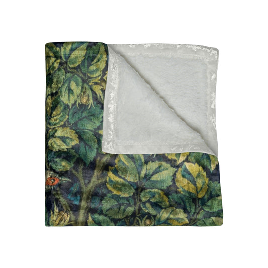 A lush crushed velvet blanket with a floral William Morris & Co pattern in shades of green and yellow, hemmed edges, and a silky finish.