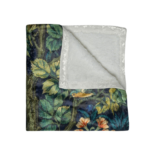 A lush crushed velvet blanket with a floral William Morris & Co  and squirrel motifs, hemmed edges, displayed unfolded.