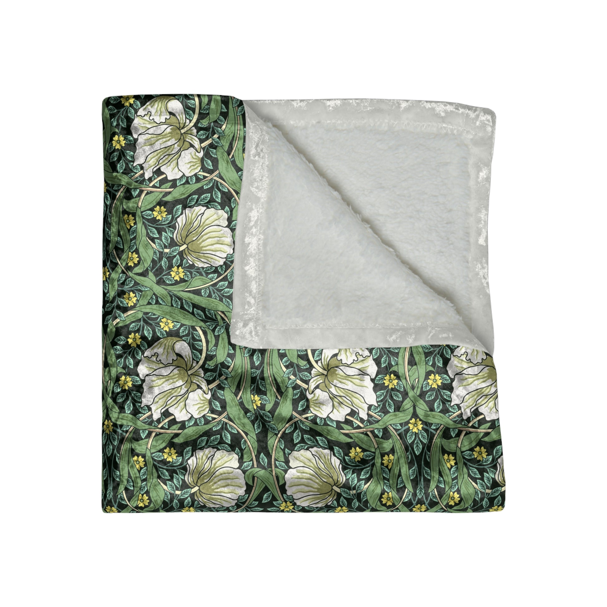 A lush crushed velvet blanket in green with a William Morris & Co floral pattern, hemmed edges, and a silky finish.