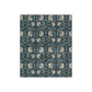 A blanket with a crushed velvet texture featuring a geometric pattern in a slate blue color.