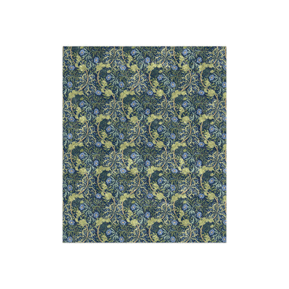 A plush blue floral patterned velvet blanket with hemmed edges and a silky finish.
