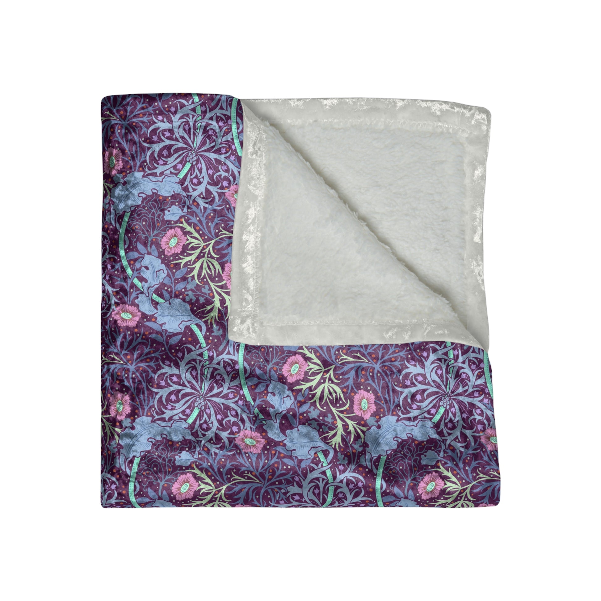 A plush velvet blanket with a floral William Morris & Co pattern in pink and purple hues, featuring hemmed edges and a silky finish.