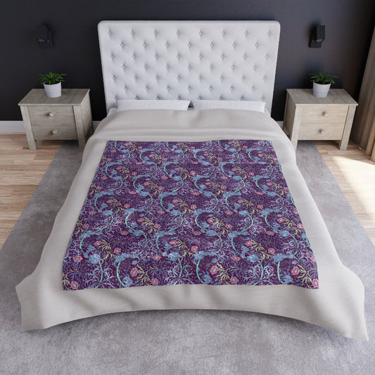 A plush velvet blanket with a floral William Morris & Co pattern in pink and purple hues, featuring hemmed edges and a silky finish.