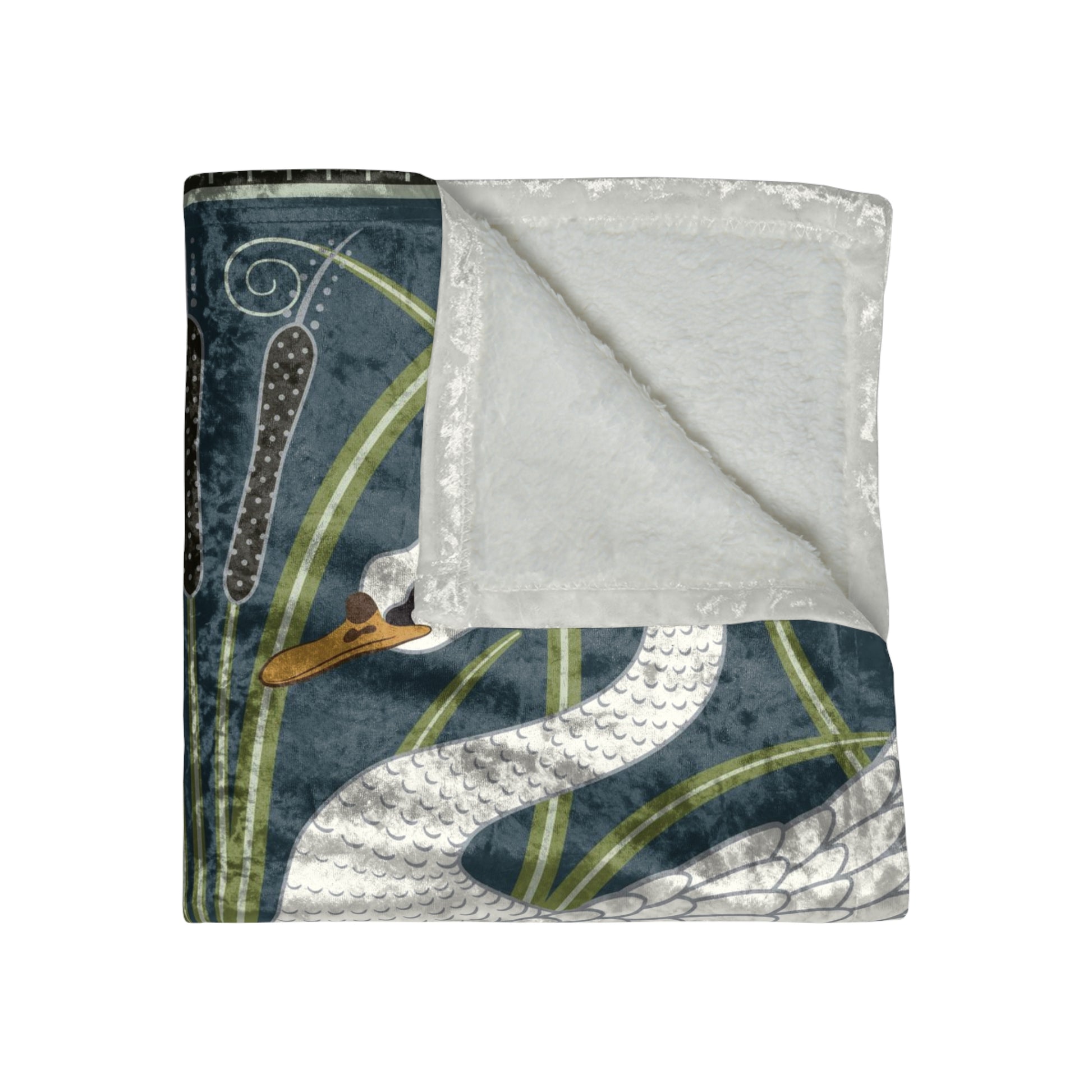 A lush crushed velvet blanket with a pattern inspired by William Morris, featuring a white swan design on a blue background, folded open to show the silky finish.