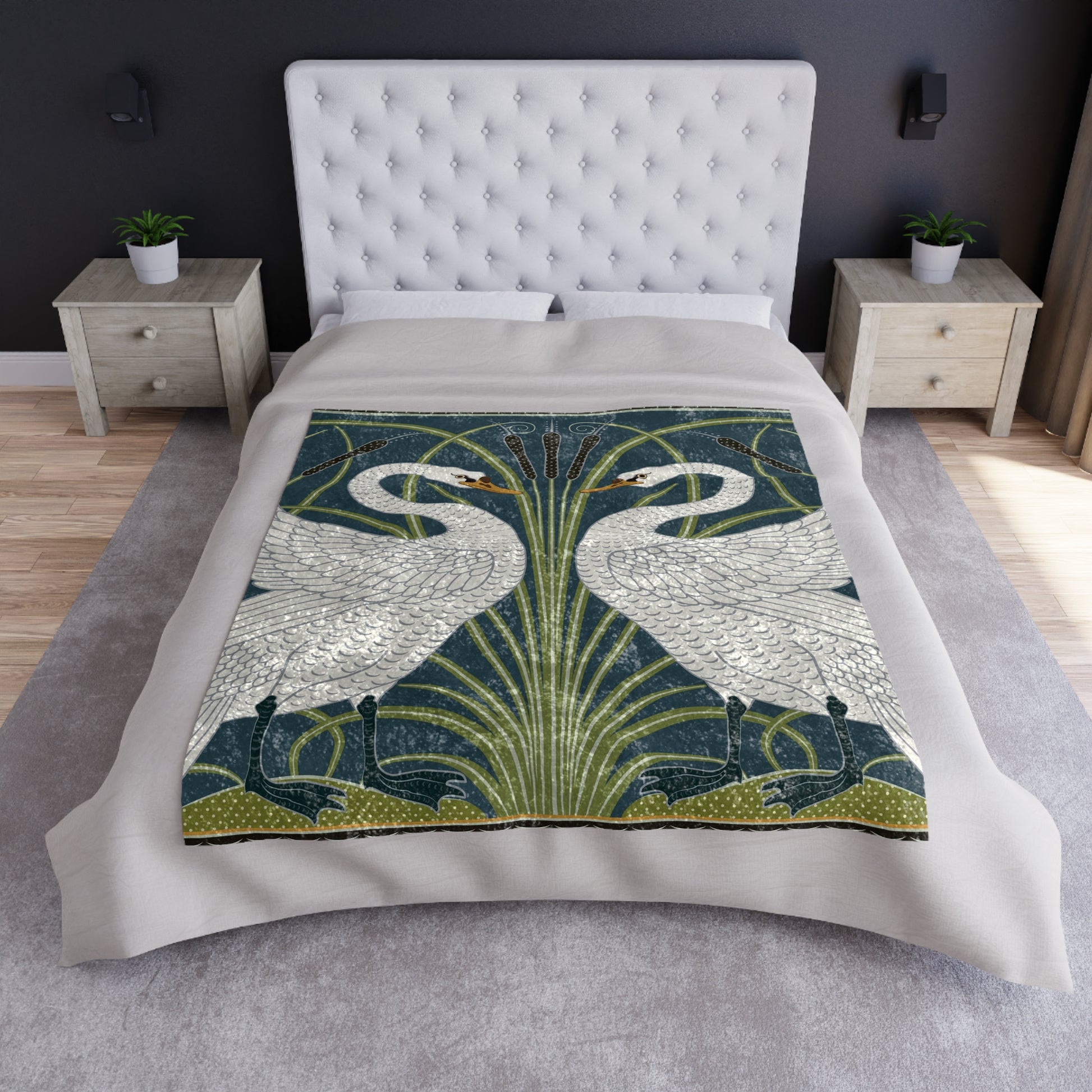 A lush crushed velvet blanket with a pattern inspired by William Morris, featuring a white swan design on a blue background, folded open to show the silky finish.