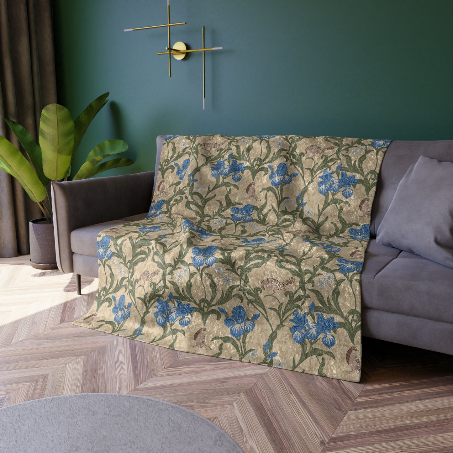 A plush velvet blanket with a floral William Morris & Co pattern in blue and yellow colours on a beige background, displayed on a flat surface.