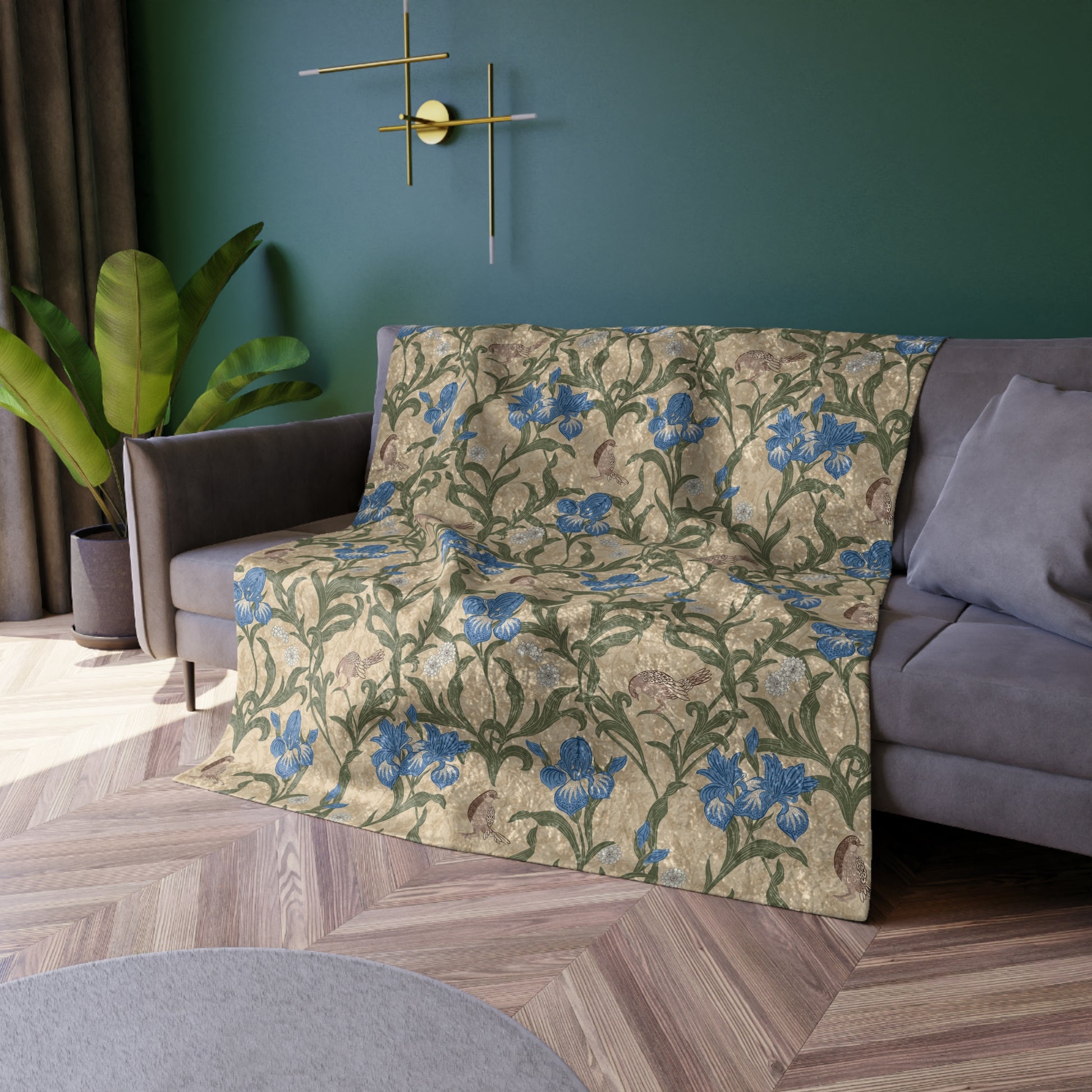 A plush velvet blanket with a floral William Morris & Co pattern in blue and yellow colours on a beige background, displayed on a flat surface.
