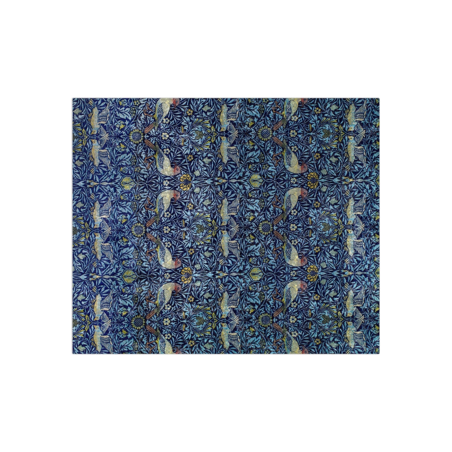 A lush crushed velvet blanket with a blue floral William Morris & Co pattern on the surface and a silky finish, hemmed edges, and a white interior visible at one end.