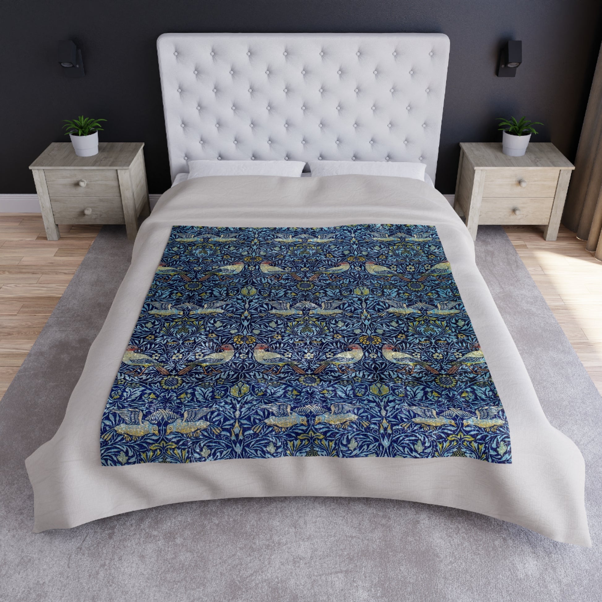 A lush crushed velvet blanket with a blue floral William Morris & Co pattern on the surface and a silky finish, hemmed edges, and a white interior visible at one end.
