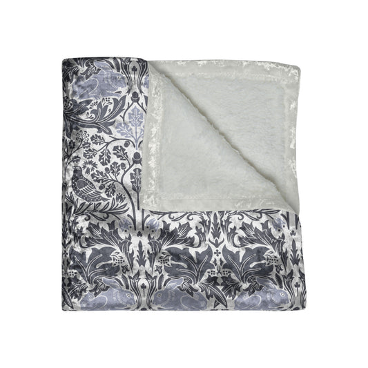Floral patterned fabric with a plain gray fabric underneath on a white background