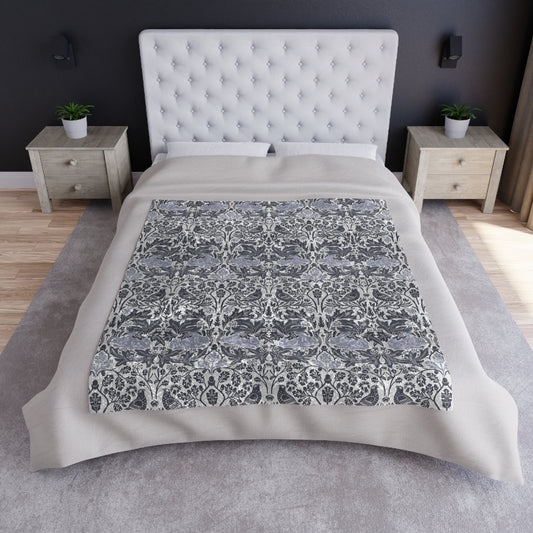 Bed with a patterned comforter in a bedroom setting
