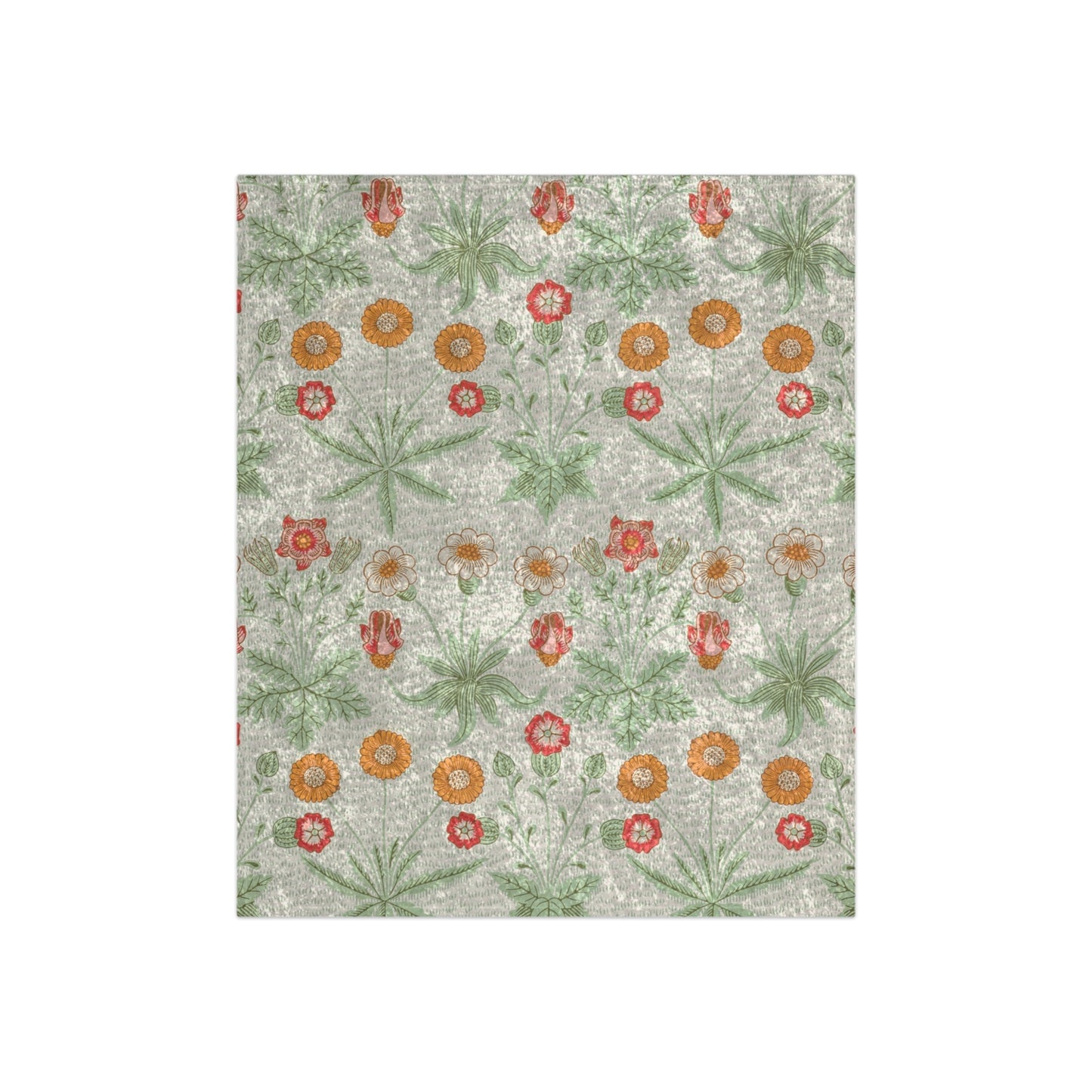 A lush crushed velvet blanket with a pattern inspired by William Morris, featuring daisy motifs in a green, red, and white color palette on a gray background.