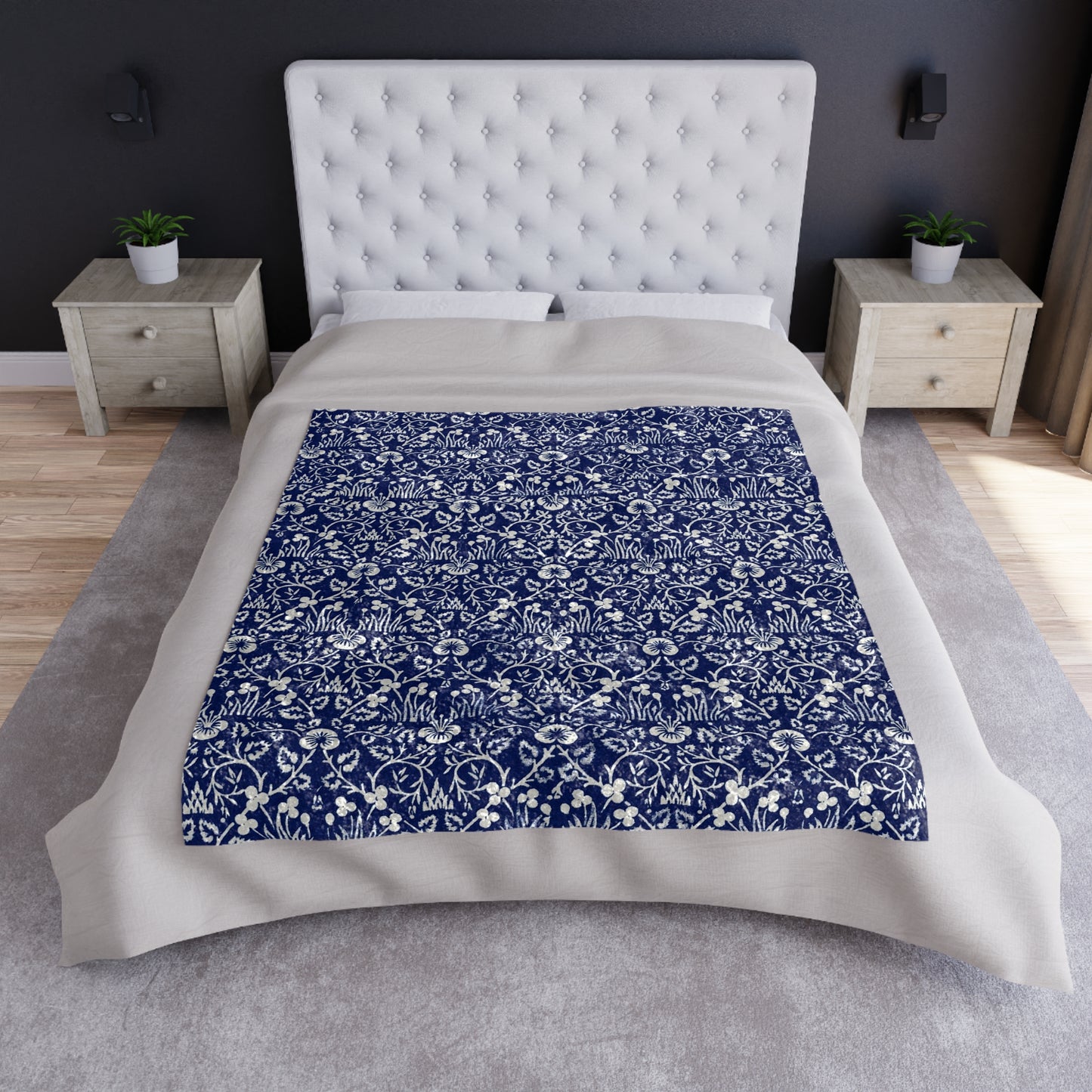 A crushed velvet blanket with a floral William Morris & Co pattern in a navy blue colour on a white background, hemmed edges, and a silky finish.