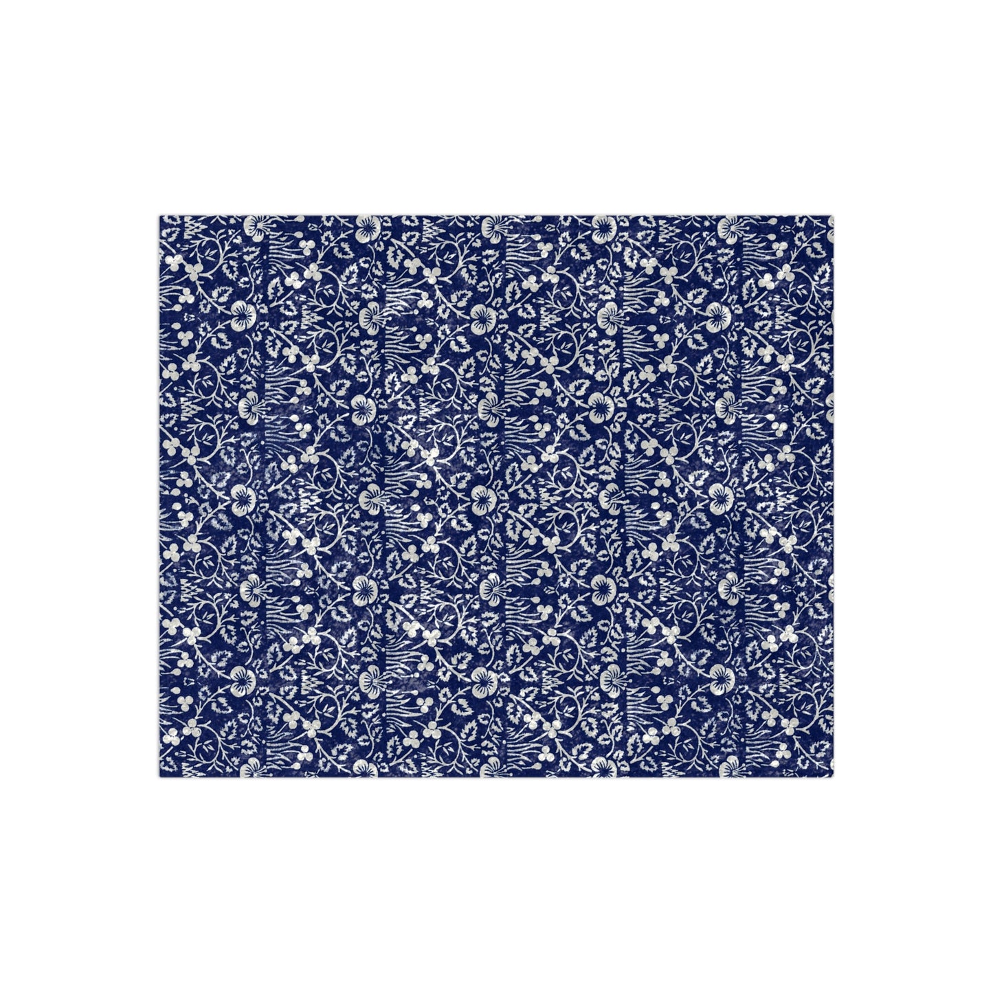 A crushed velvet blanket with a floral William Morris & Co pattern in a navy blue colour on a white background, hemmed edges, and a silky finish.