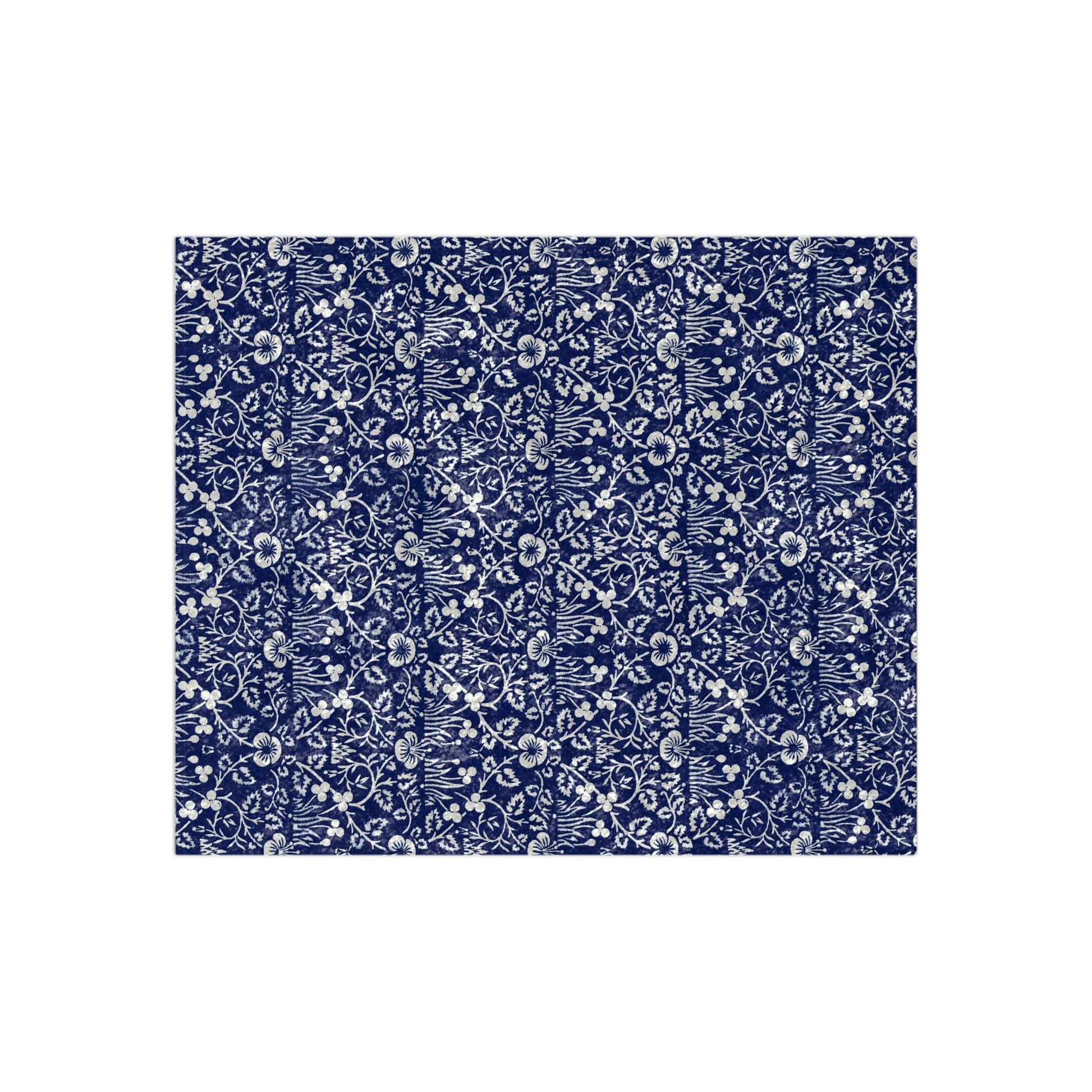 A crushed velvet blanket with a floral William Morris & Co pattern in a navy blue colour on a white background, hemmed edges, and a silky finish.