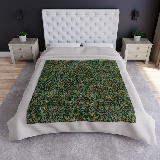 A lush crushed velvet blanket with a floral William Morris & Co pattern in green and brown colours, displayed on a white background.