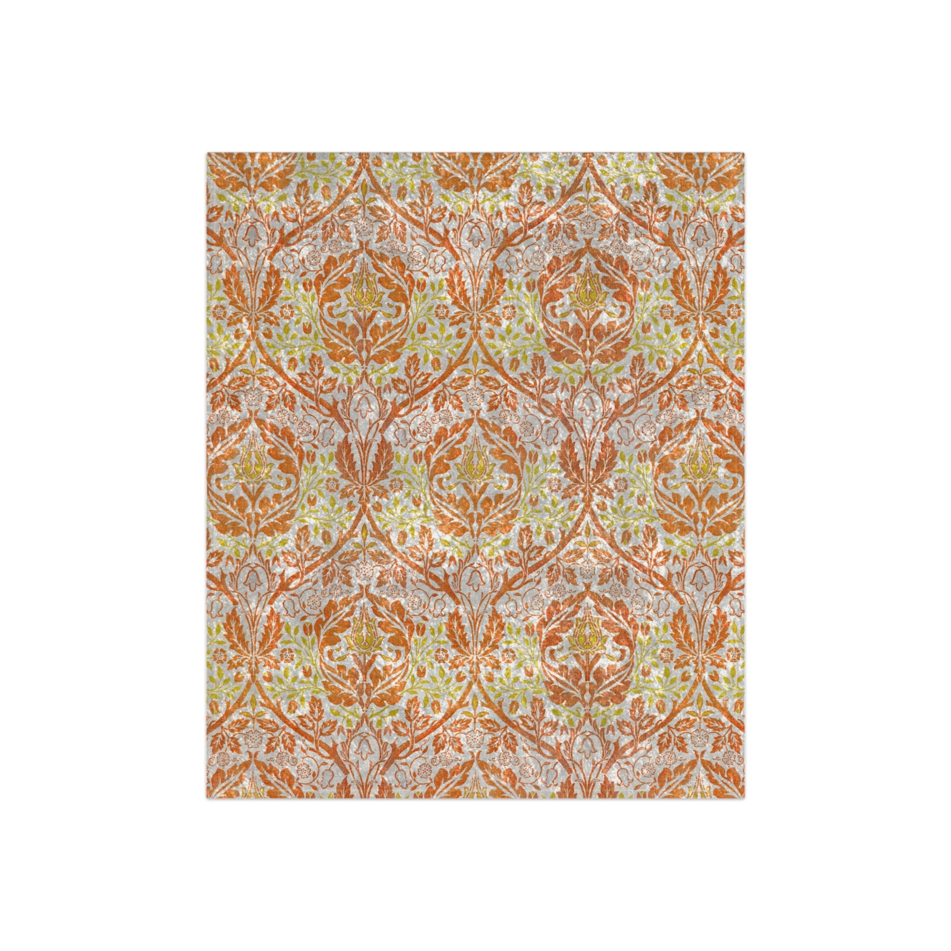 A crushed velvet blanket with a William Morris & Co floral pattern in shades of orange, yellow, and green on a white background, folded to show both the patterned side and the solid silky finish.