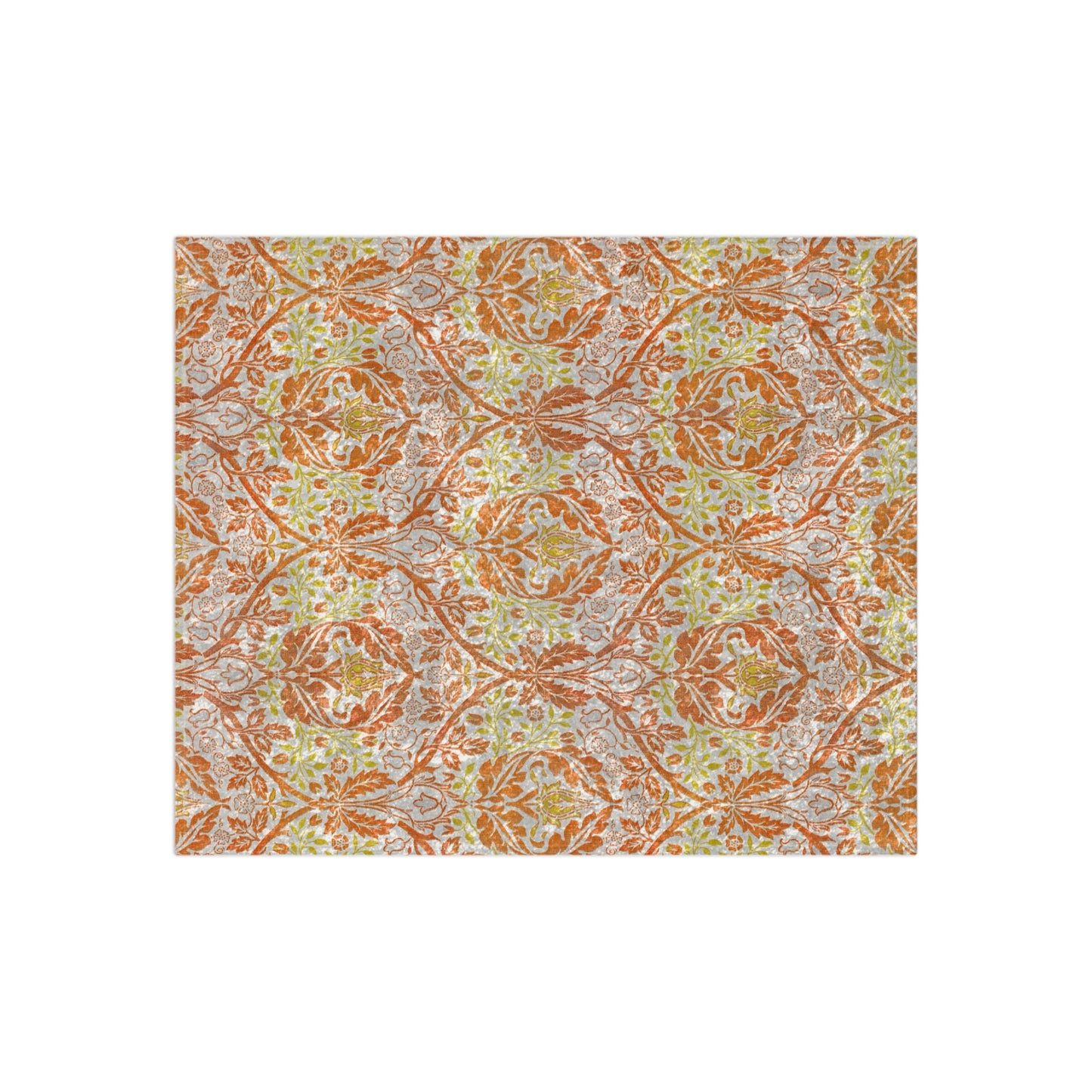 A crushed velvet blanket with a William Morris & Co floral pattern in shades of orange, yellow, and green on a white background, folded to show both the patterned side and the solid silky finish.
