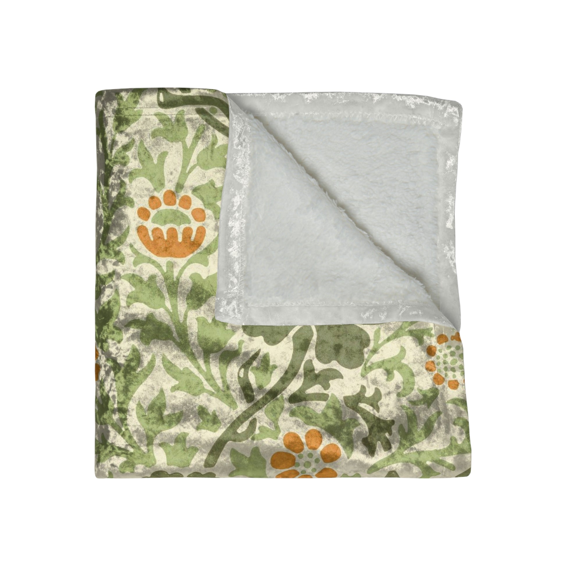 A plush, velvet blanket with aWilliam Morris  floral pattern in shades of green and orange, folded to show both the front and back with hemmed edges.