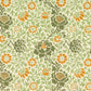 A plush, velvet blanket with aWilliam Morris  floral pattern in shades of green and orange, folded to show both the front and back with hemmed edges.