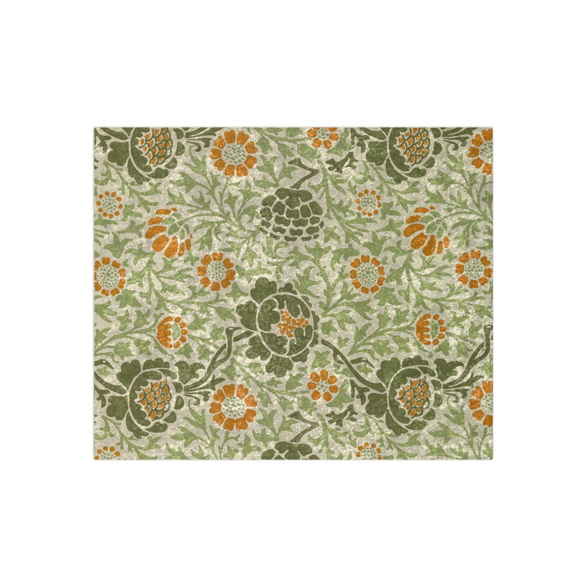 A plush, velvet blanket with aWilliam Morris  floral pattern in shades of green and orange, folded to show both the front and back with hemmed edges.