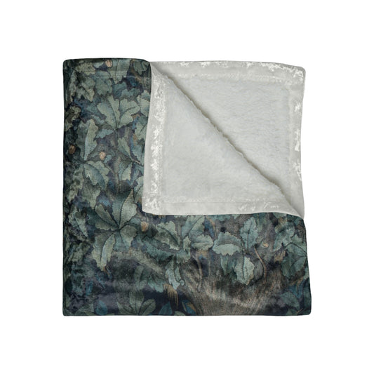 A lush crushed velvet blanket with a greenery design, inspired by William Morris, with hemmed edges and a silky finish.