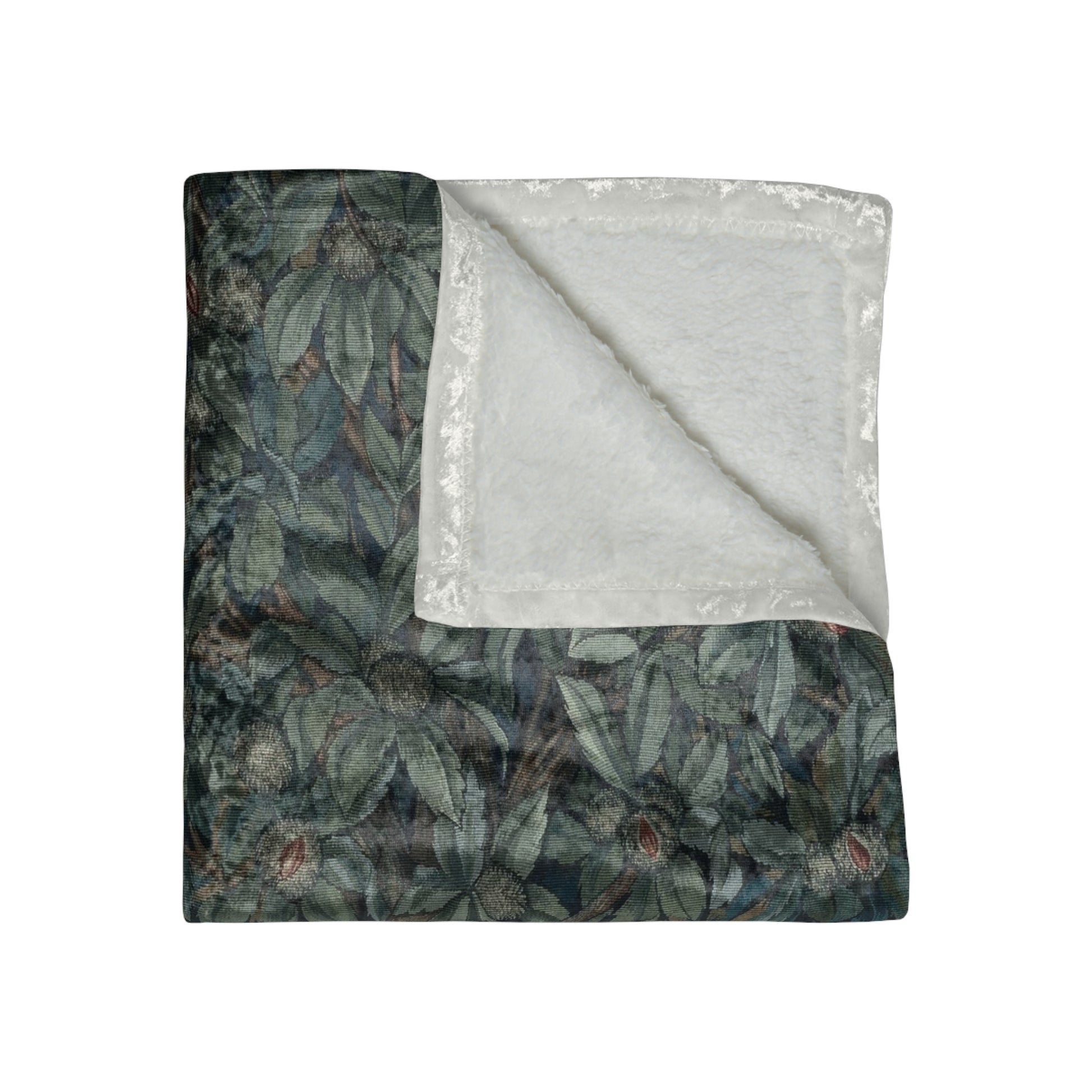 A plush velvet blanket with a William Morris & Co greenery (including leaves and fox) pattern on one side and a solid white colour on the reverse side, with hemmed edges.