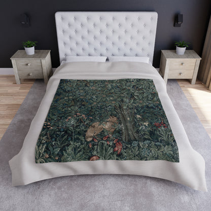 A plush velvet blanket with a greenery (including leaves and fox) pattern on one side and a solid white color on the reverse side, with hemmed edges.