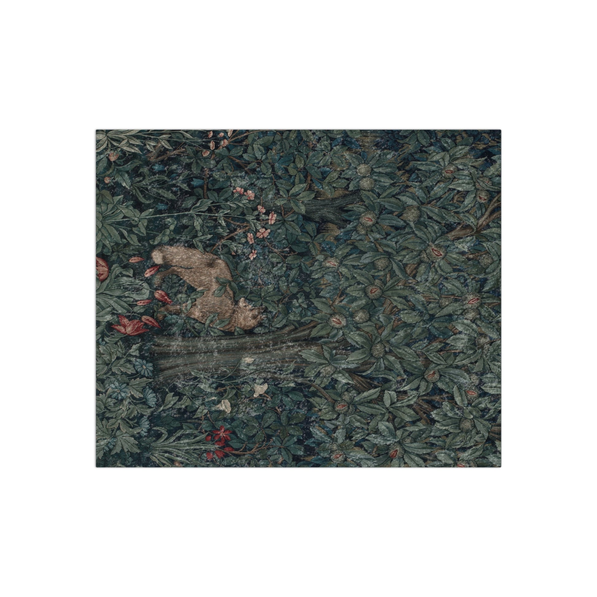 A plush velvet blanket with a William Morris & Co greenery (including leaves and fox) pattern on one side and a solid white colour on the reverse side, with hemmed edges.