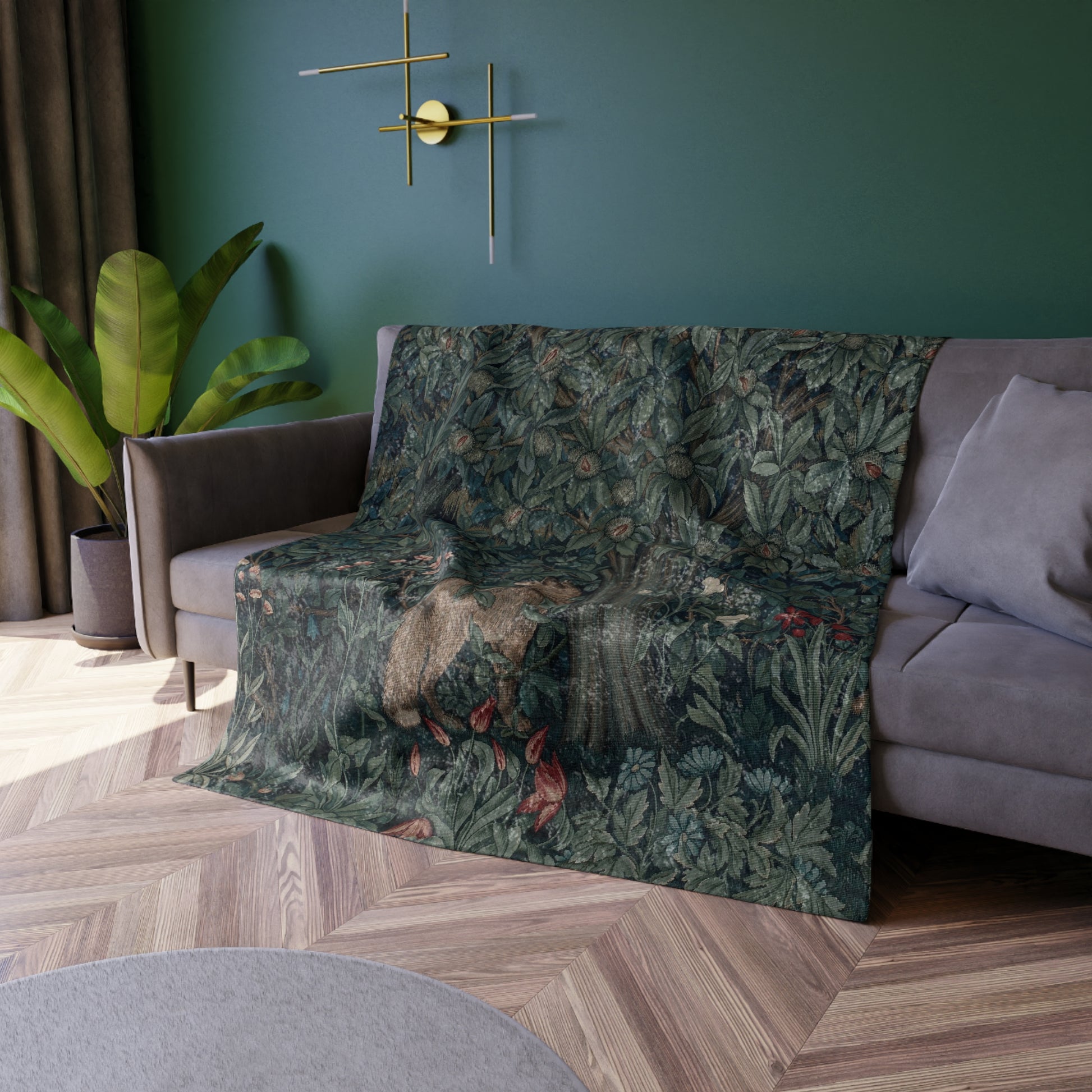 A plush velvet blanket with a William Morris & Co greenery (including leaves and fox) pattern on one side and a solid white colour on the reverse side, with hemmed edges.