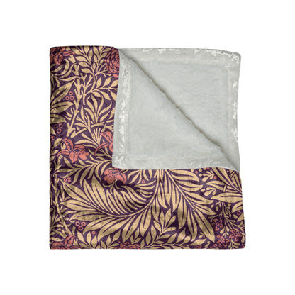 A red and brown William Morris & Co  floral patterned velvet blanket with hemmed edges and a silky finish.