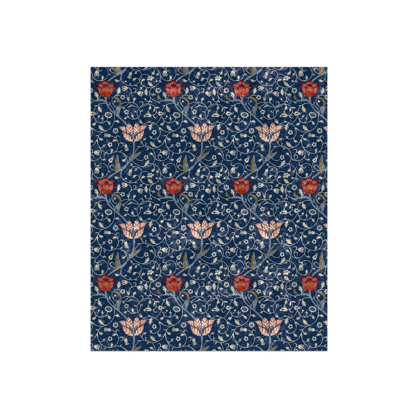 A crushed velvet blanket with a floral pattern in blue, red, and beige colors on a dark background.
