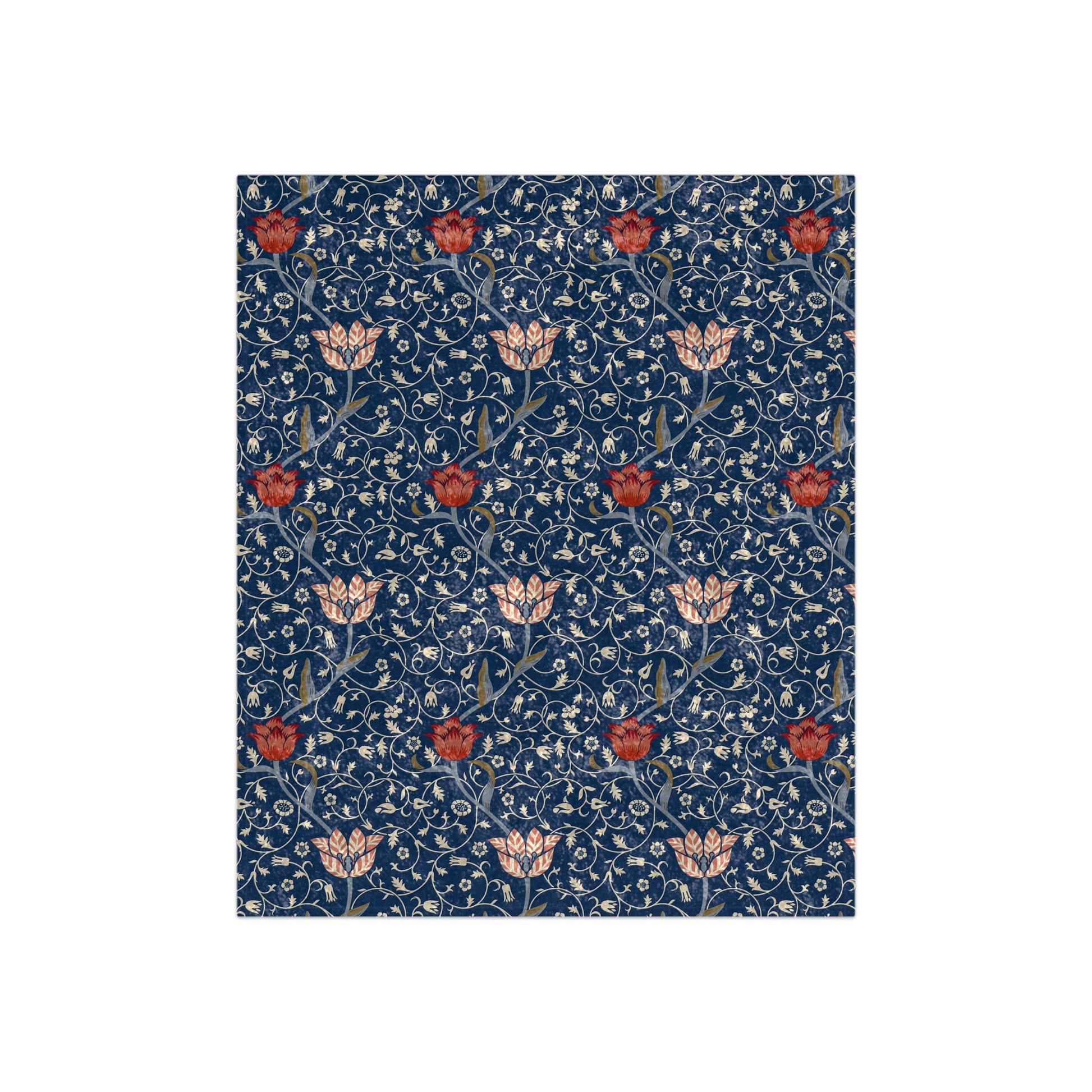 A crushed velvet blanket with a floral pattern in blue, red, and beige colors on a dark background.