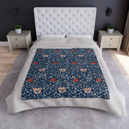 A lush crushed velvet blanket with a floral pattern in blue and red colors, inspired by William Morris, with a silky finish.