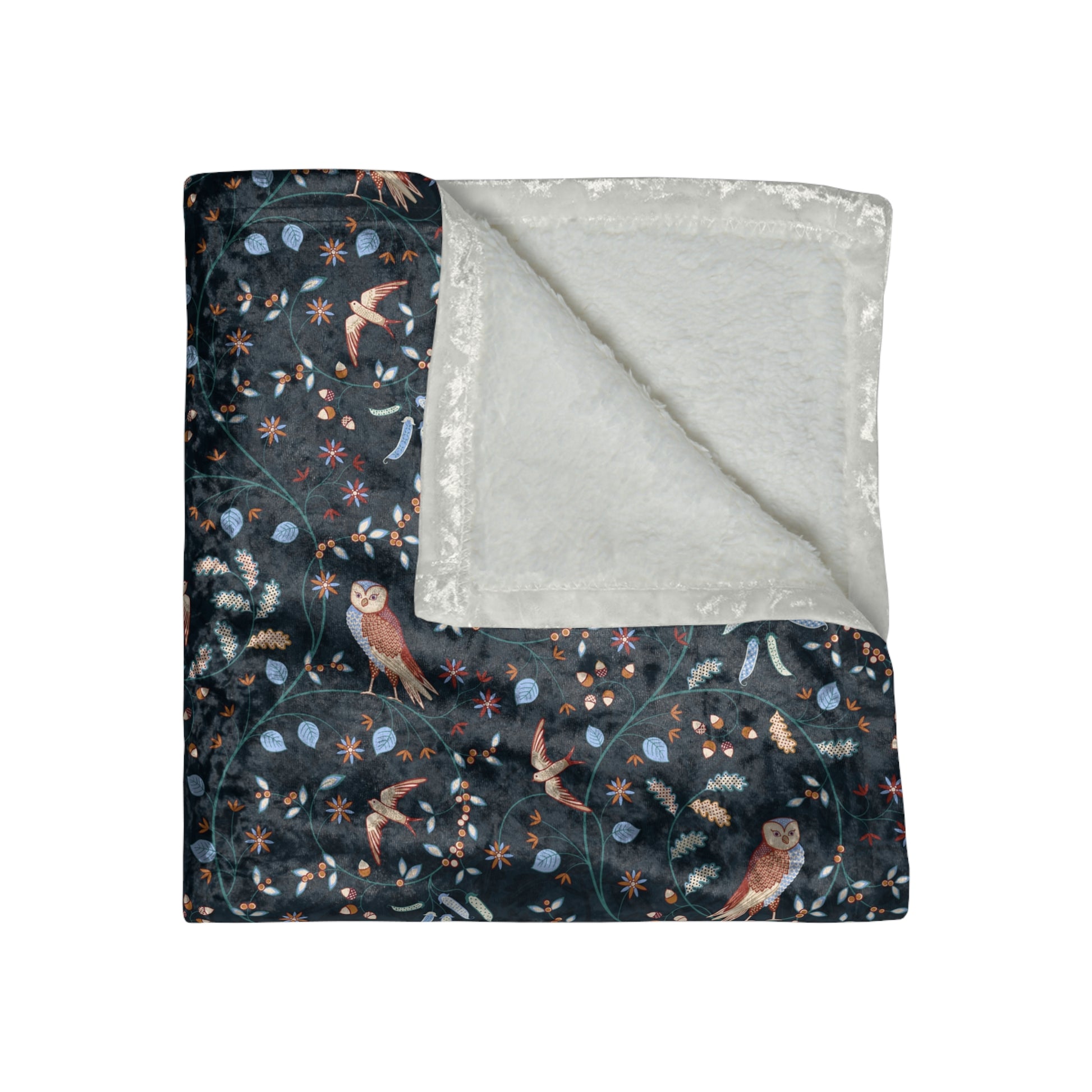 Floral and owl patterned blanket with gray reverse side on a white background