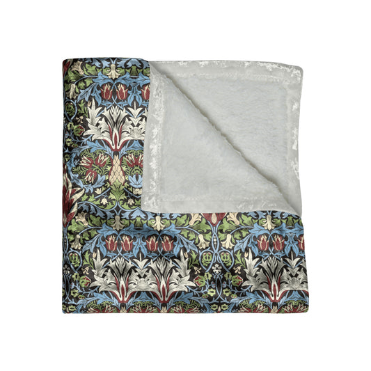 Floral patterned blanket with a gray reverse side on a white background