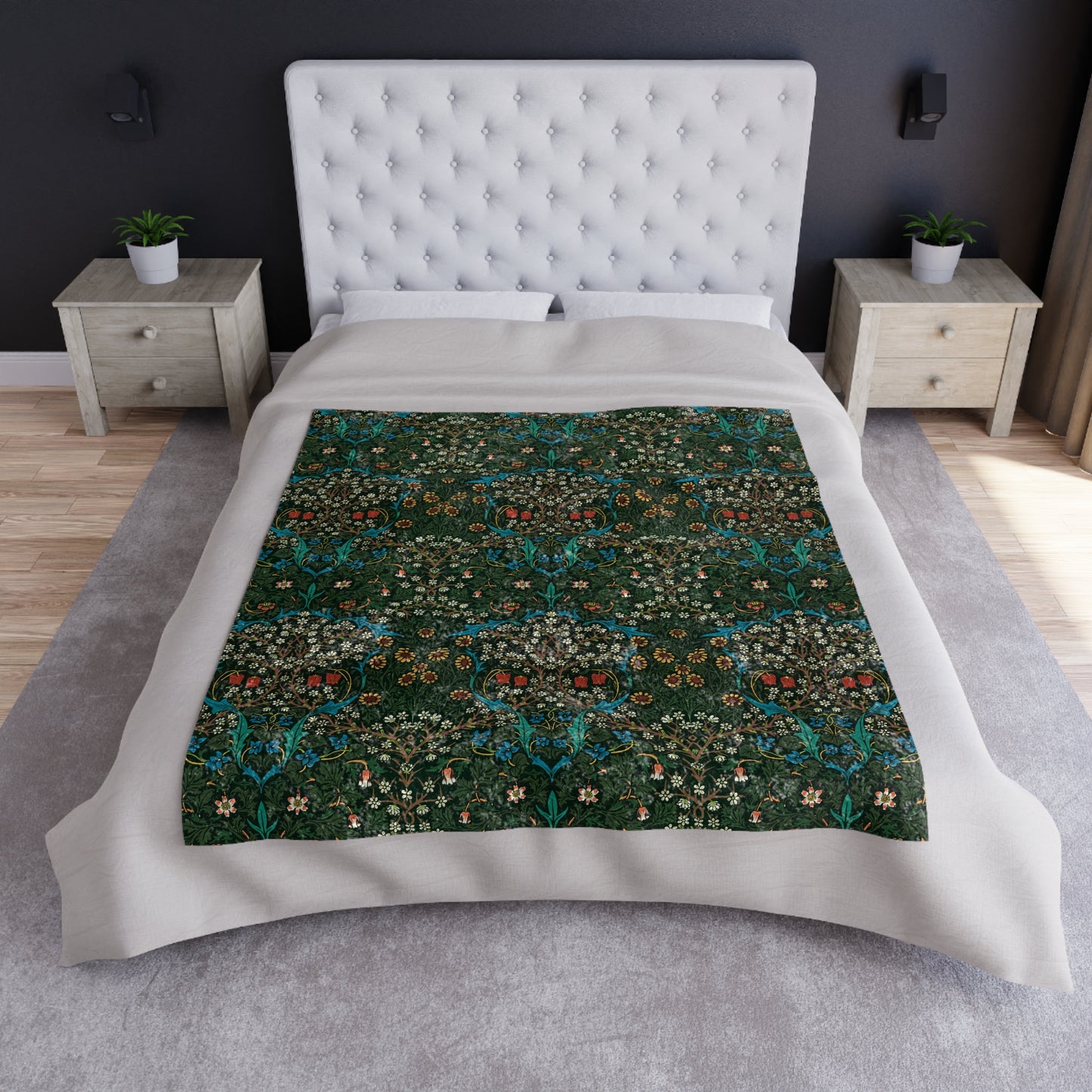 A lush crushed velvet blanket with a floral pattern in red and green colors, displayed on a flat surface.