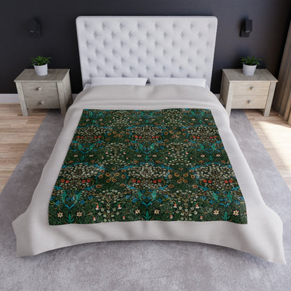 A lush crushed velvet blanket with a floral pattern in red and green colors, displayed on a flat surface.