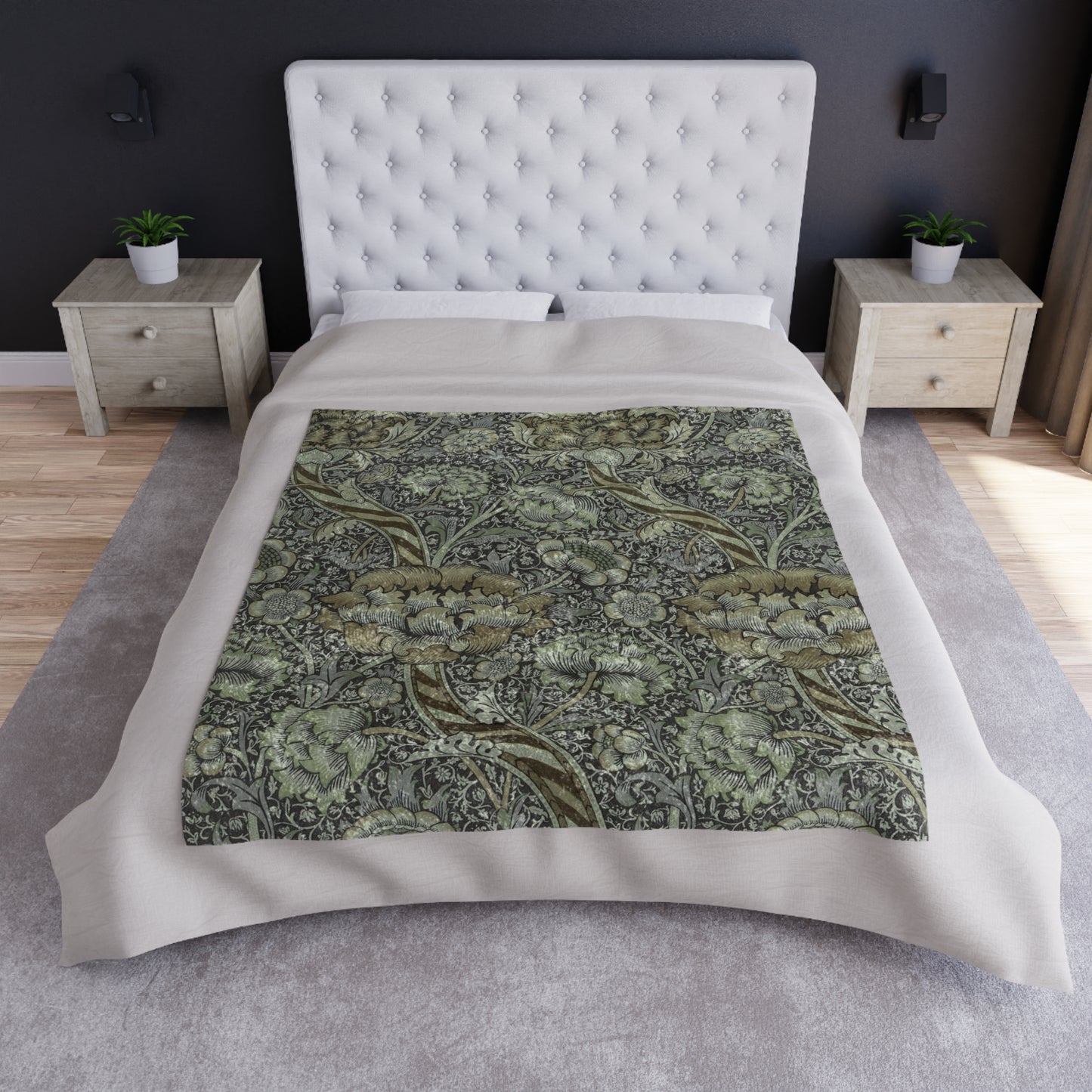 A crushed velvet blanket with a floral pattern in muted colors, folded to show both the patterned side and the solid gray reverse.