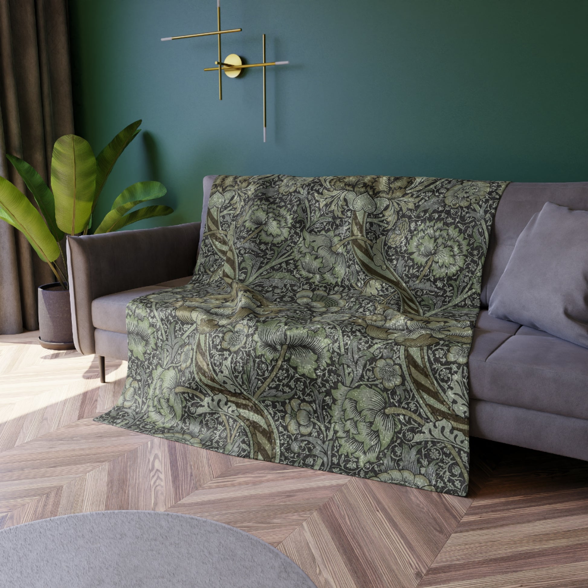 A crushed velvet blanket with a floral pattern in muted colors, folded to show both the patterned side and the solid gray reverse.