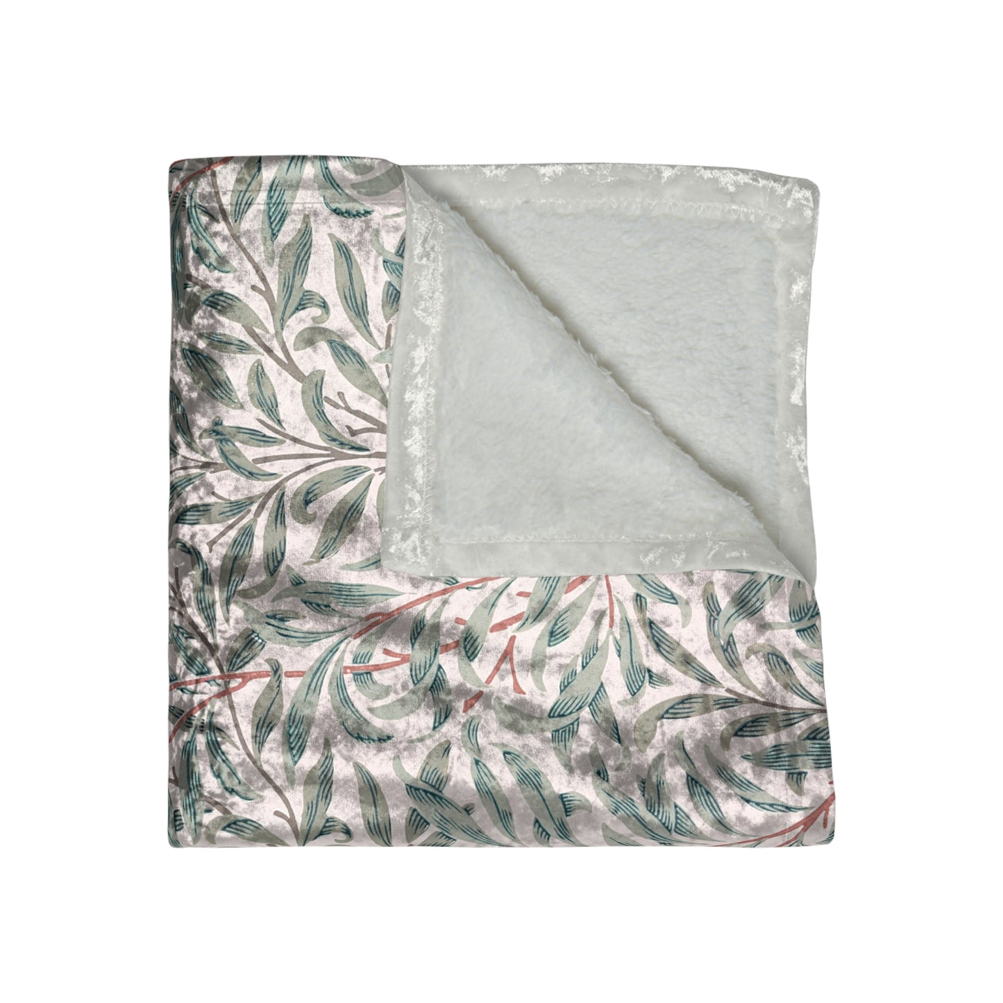 A crushed velvet blanket with a floral William Morris & Co pattern in green and red on a white background, hemmed edges, and a silky finish.