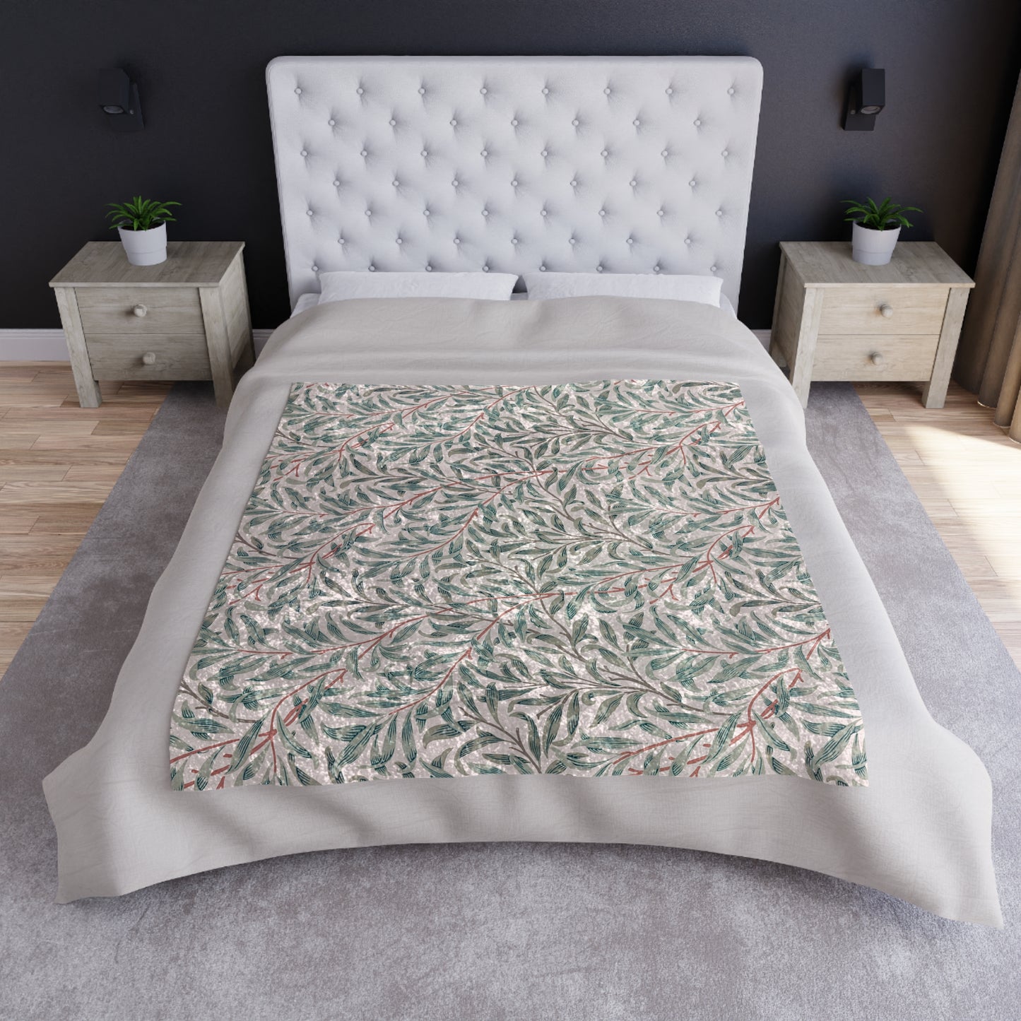 A crushed velvet blanket with a floral William Morris & Co pattern in green and red on a white background, hemmed edges, and a silky finish.