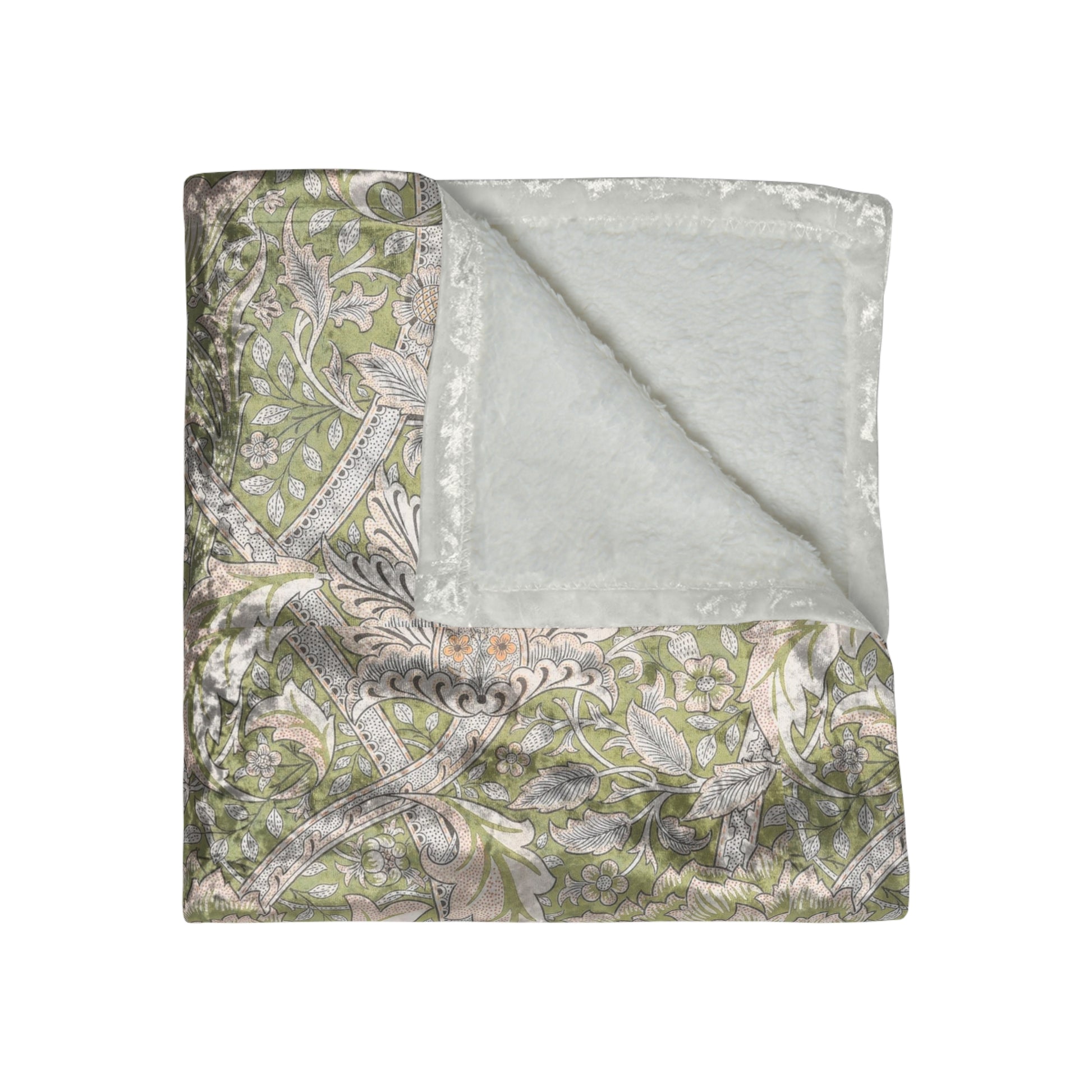 A plush, velvet blanket with a floral William Morris & Co pattern in shades of green and beige, laid out with the soft side up.