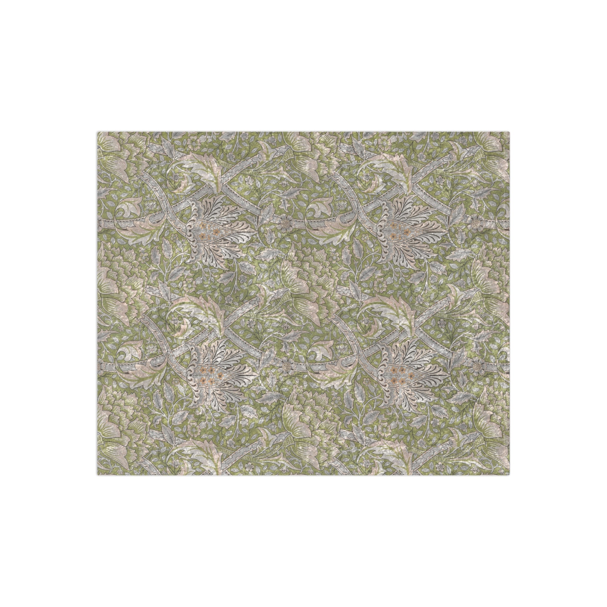 A plush, velvet blanket with a floral William Morris & Co pattern in shades of green and beige, laid out with the soft side up.