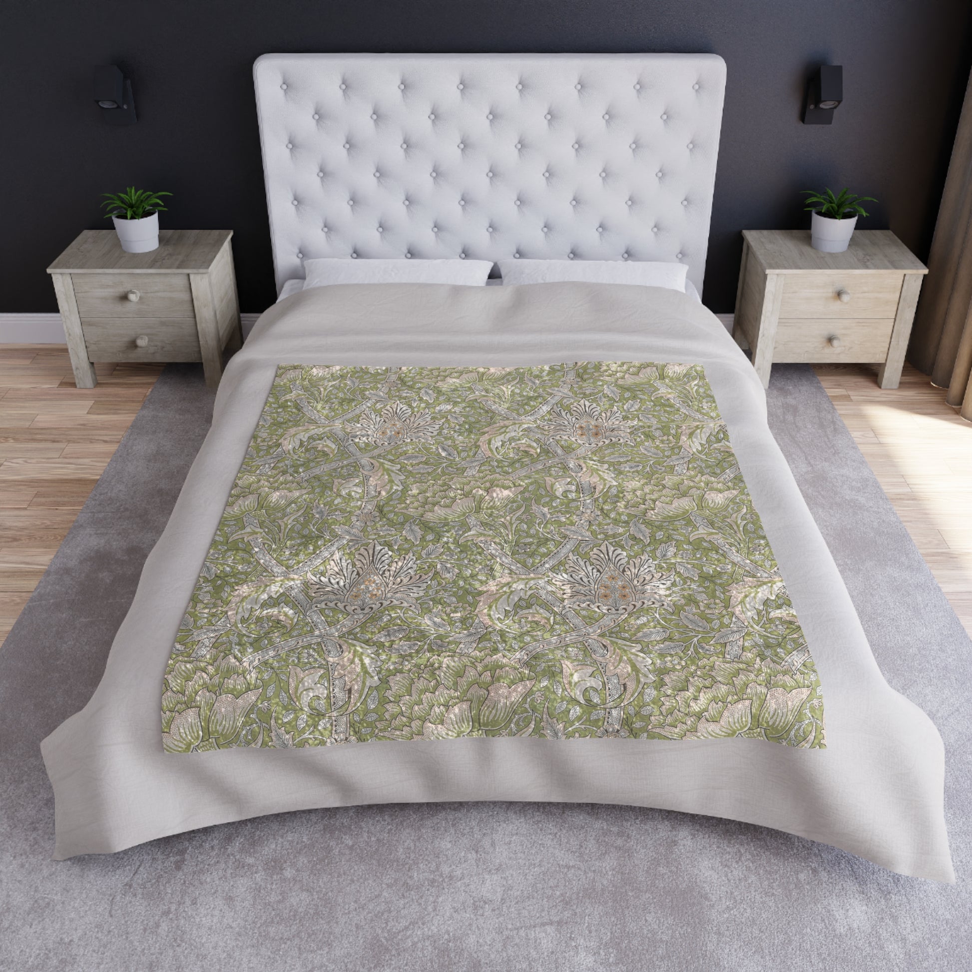 A plush, velvet blanket with a floral William Morris & Co pattern in shades of green and beige, laid out with the soft side up.