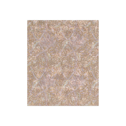 A plush, velvet blanket with a floral pattern in muted colors, folded to show both the front and back.