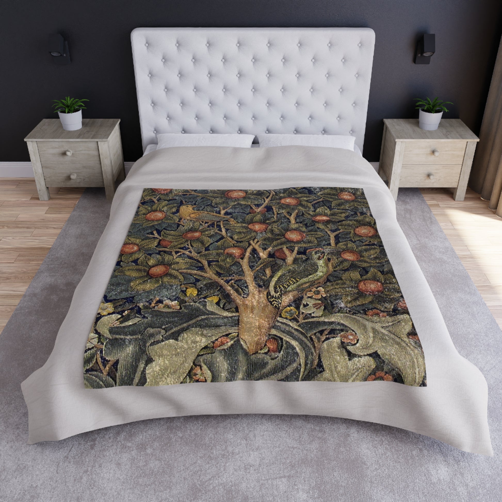 A lush crushed velvet blanket with a floral pattern inspired by William Morris, displayed in an folded arrangement to show both the patterned side and the silky finish.